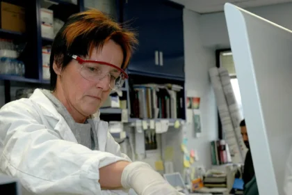 Laboratory scientist examining samples under a microscope