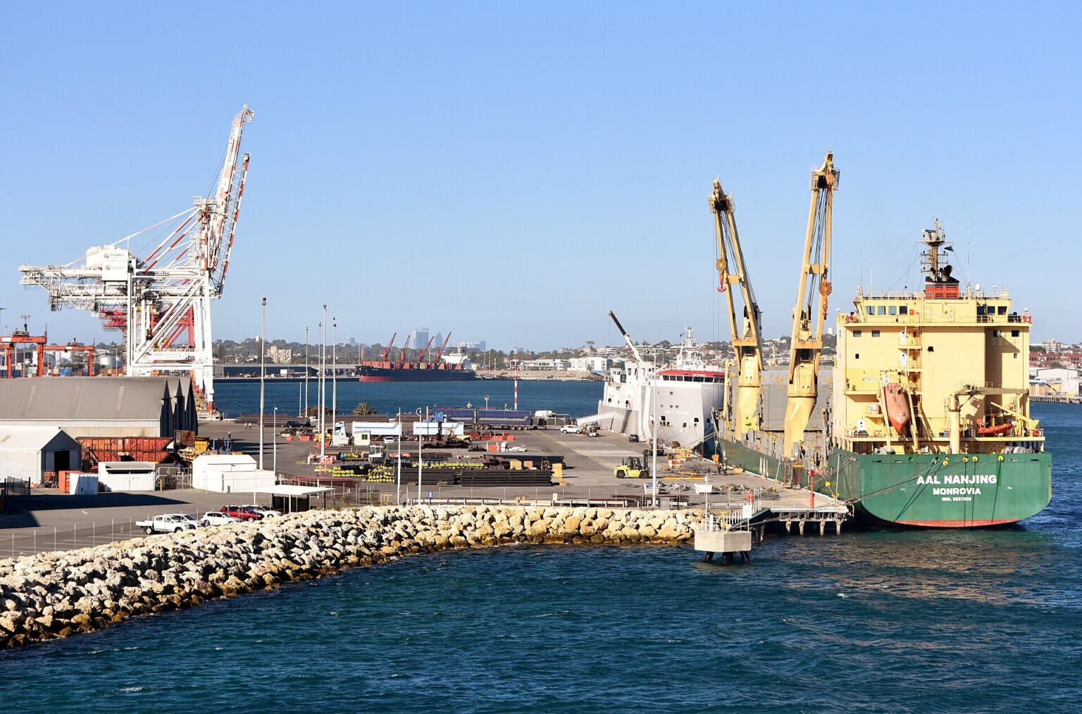 Container cranes loading a cargo ship in a harbour